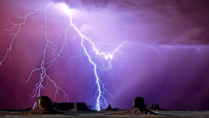 lightning and purple sky over Monument Valley in Arizona